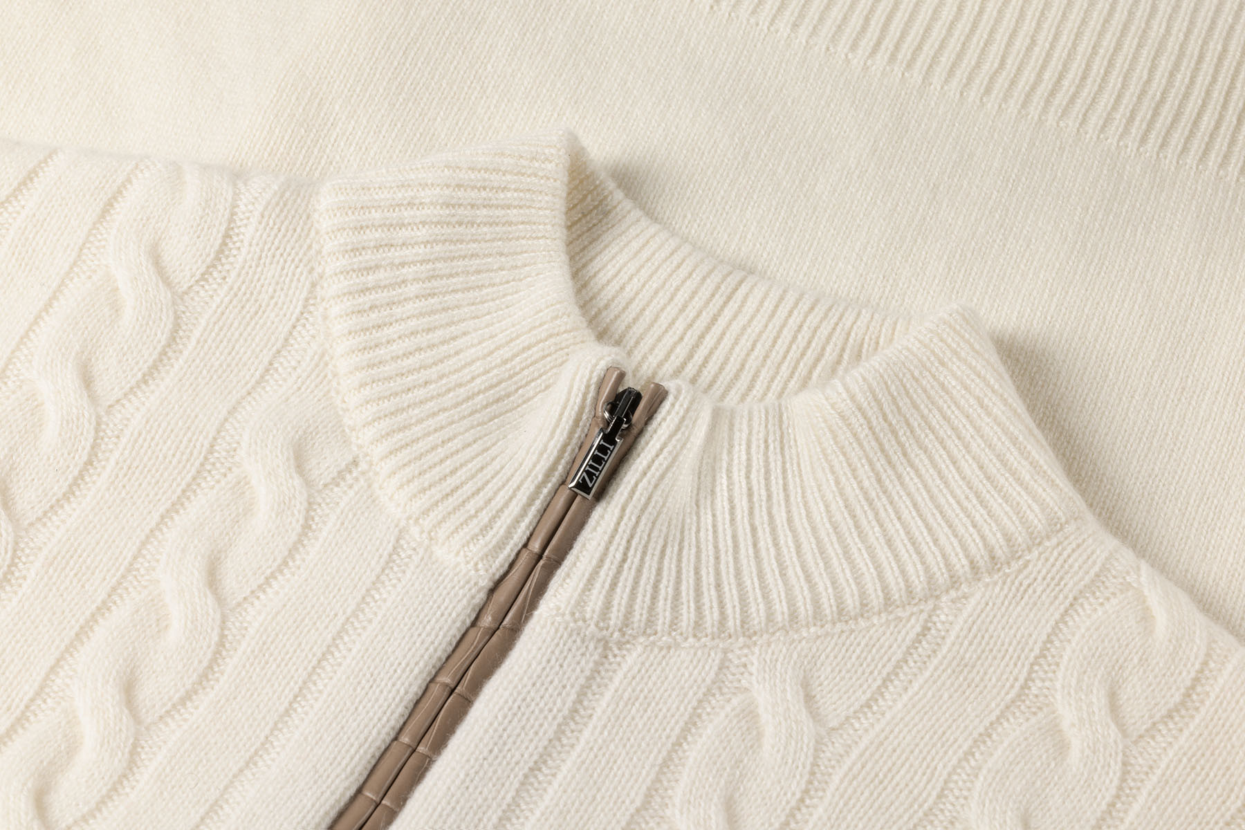 Cream zipped funnel-neck sweater, twisted jacquard weave, crocodile details